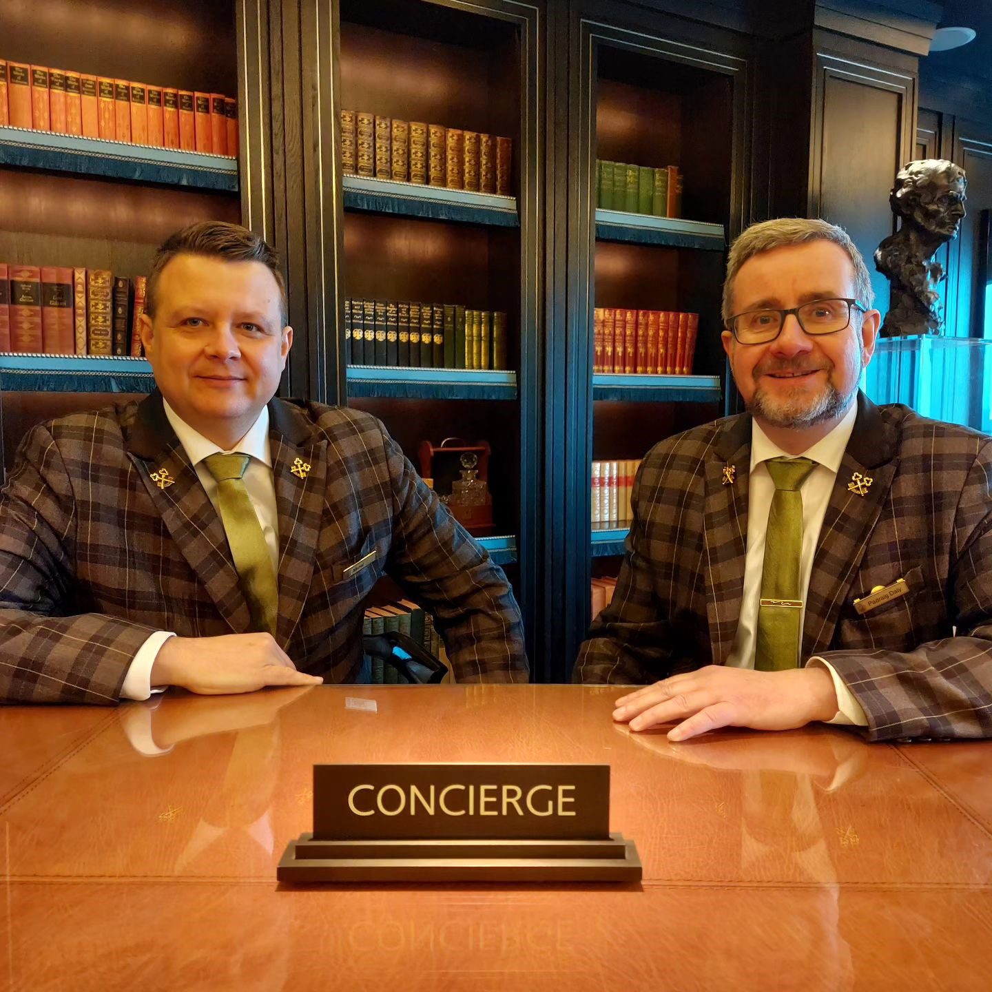 hotel concierge in brown and yellow tartan suit