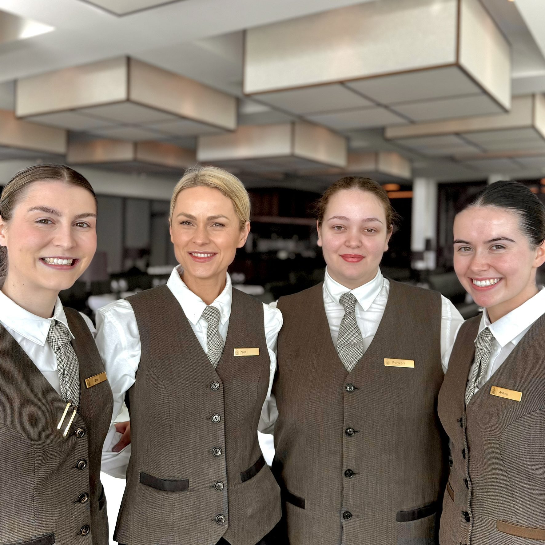4 ladies wearing luxury brown hotel uniform